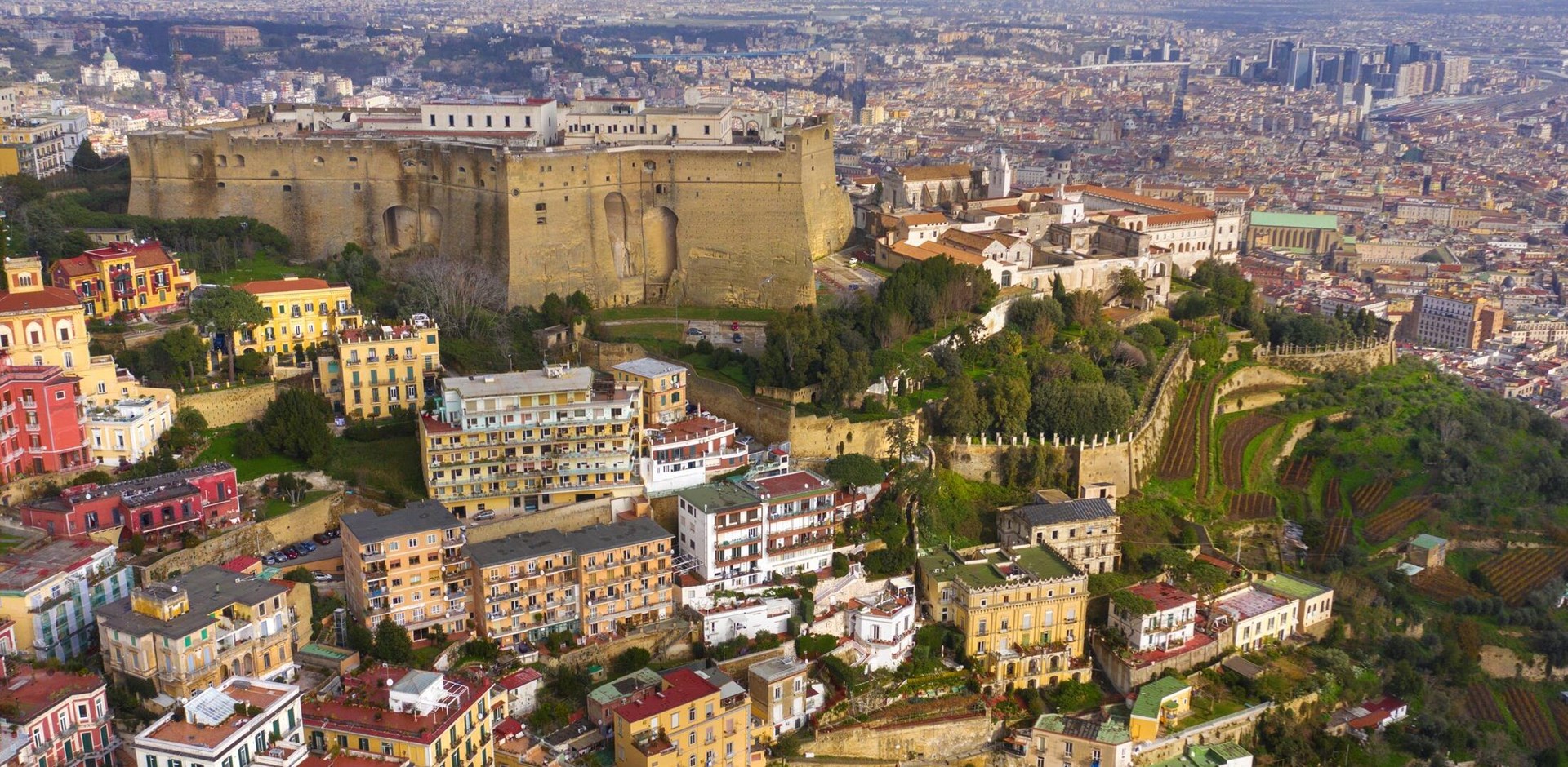 Aerial view of Castel Sant'elmo in Naples, Italy. The Castle is located in the Vomero district and overlooks the town. In background the downtown of  the city.