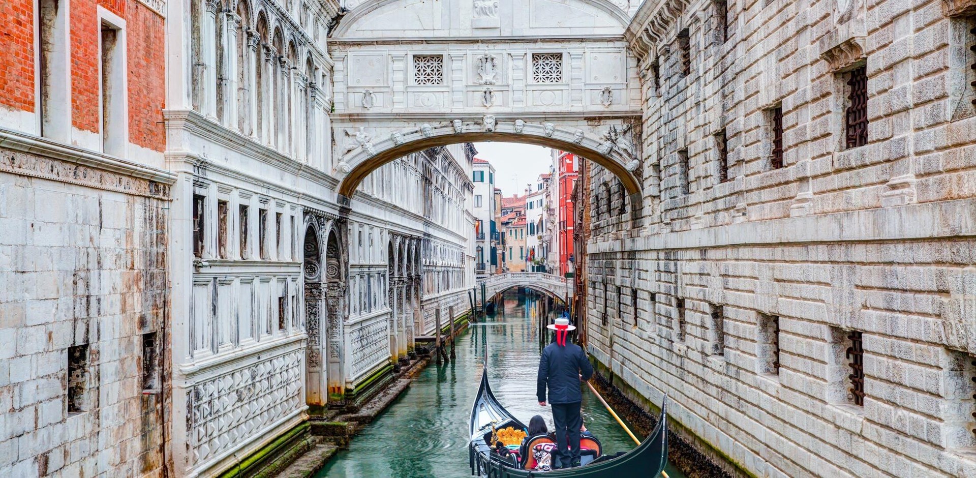 Gondolas floating on canal towards Bridge of Sighs (Ponte dei Sospiri). Venice, Italy