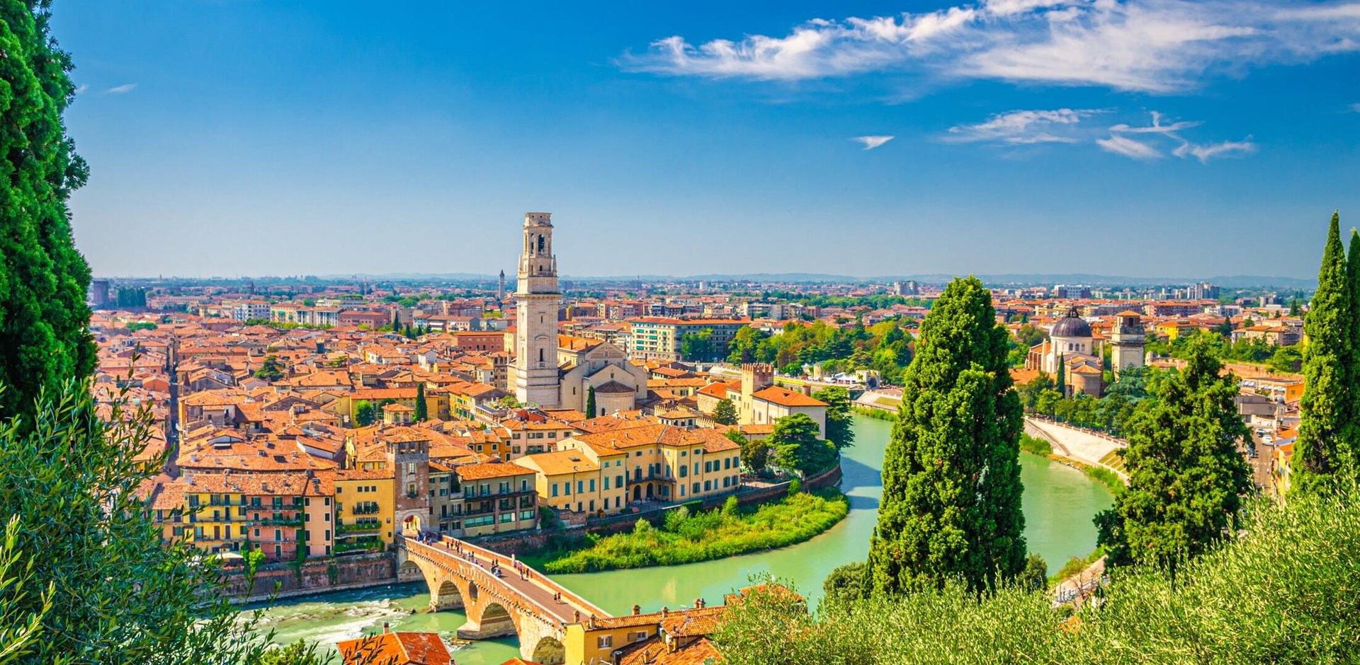 Aerial view of Verona historical city centre, Ponte Pietra bridge across Adige river, Verona Cathedral, Duomo di Verona, red tiled roofs, Veneto Region, Italy. Verona cityscape, panoramic view.