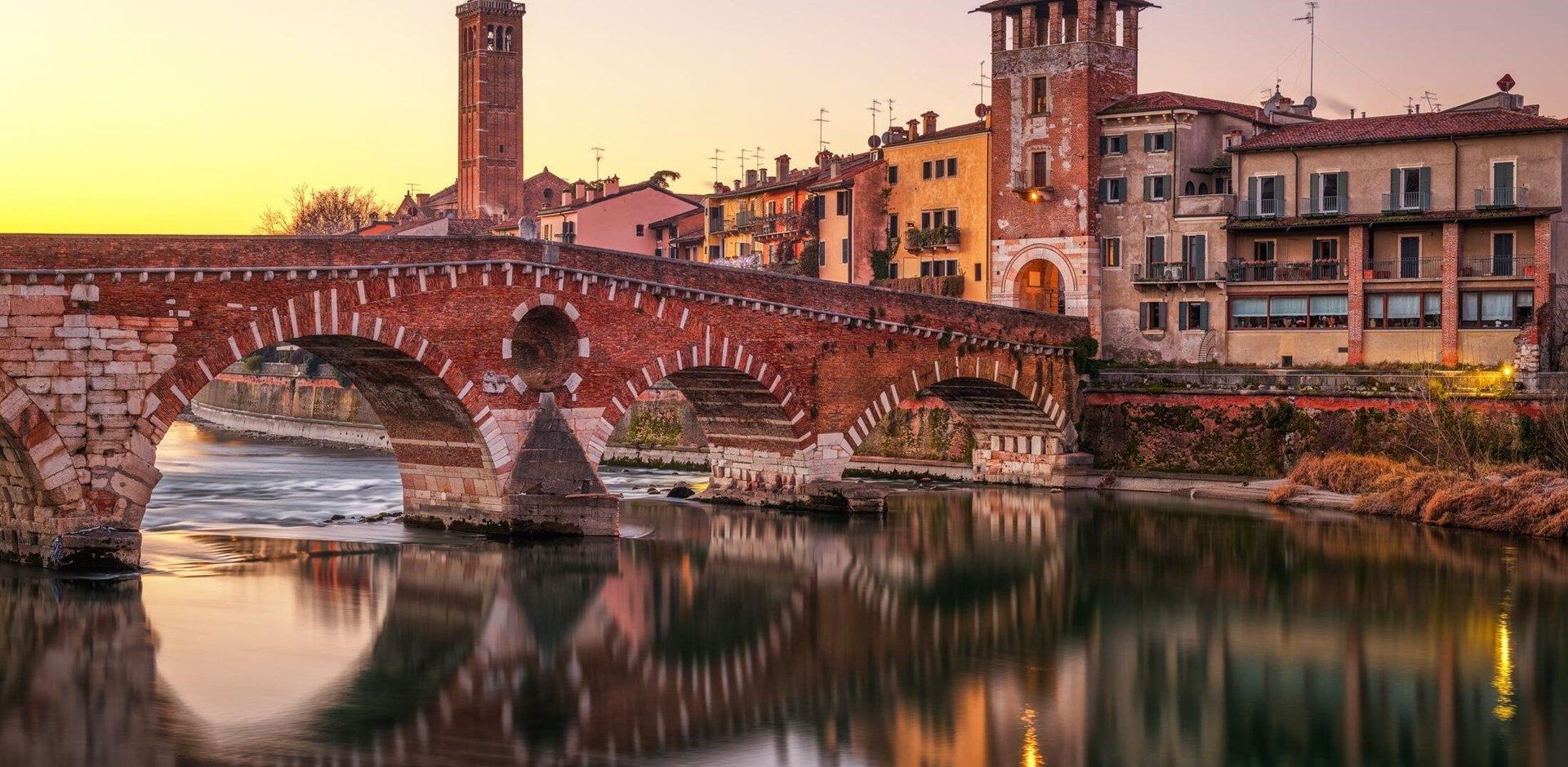 Verona, Italy Town Skyline on the Adige River with Ponte Pietra at dawn.