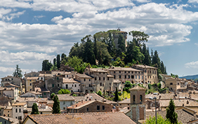 Magnificent view of the ancient hilltop village of Cetona, Siena, Italy, on a beautiful sunny day with some white clouds