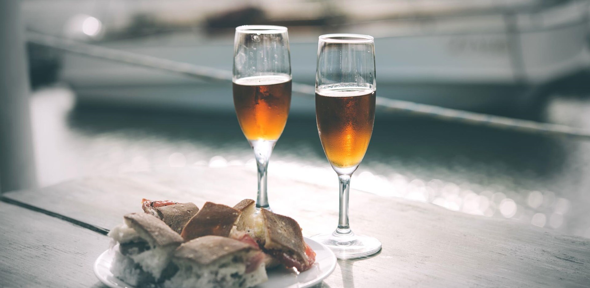 Marsala wine and typical Sicilian snacks are served for aperitivo in Marsala, Sicily, Italy.. Toned picture