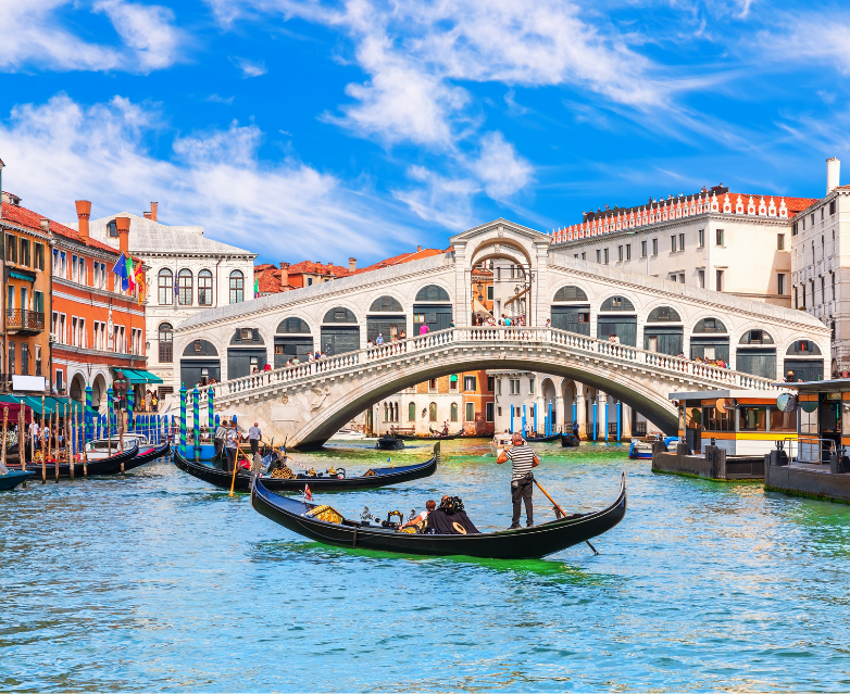 a boat that is floating in the water with Rialto Bridge in the background